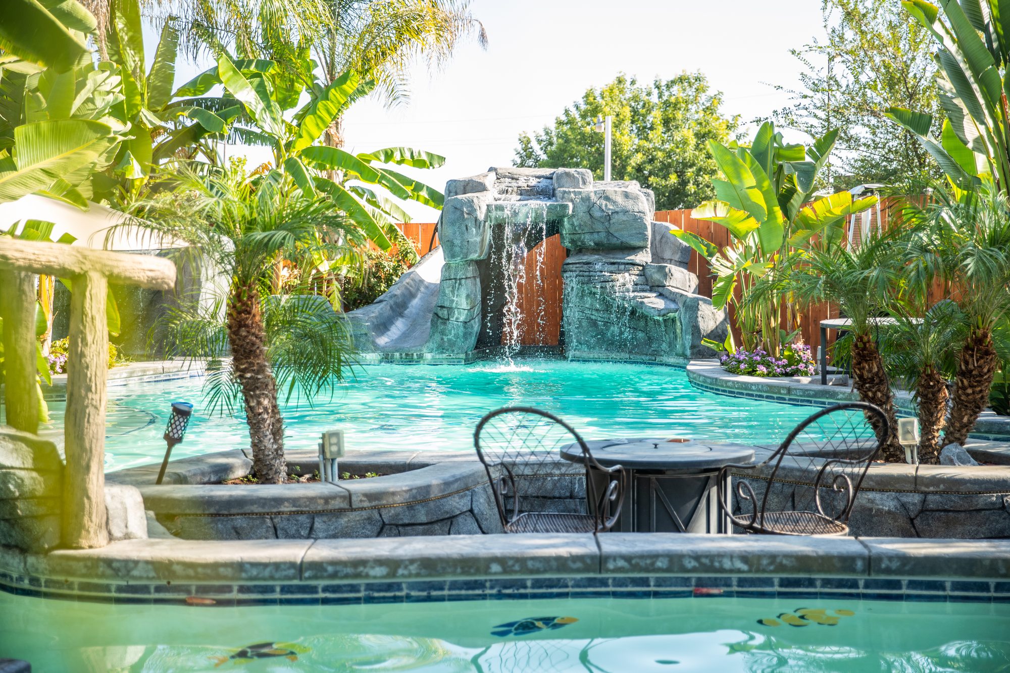 Resort-style lagoon pool with rock waterfalls built by Neighborhood Pool Service