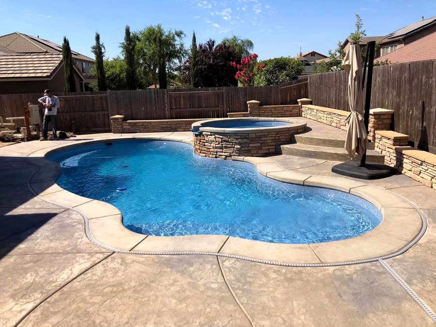 Kidney + Raised Spa — pool built by Neighborhood Pool Service